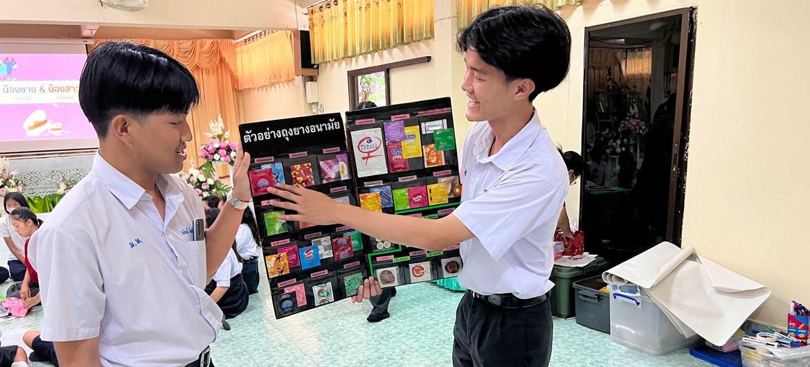 Two Thai peer educators High School students describe a number of available condoms. Two Thai peer educators High School students describe a number of available condoms.