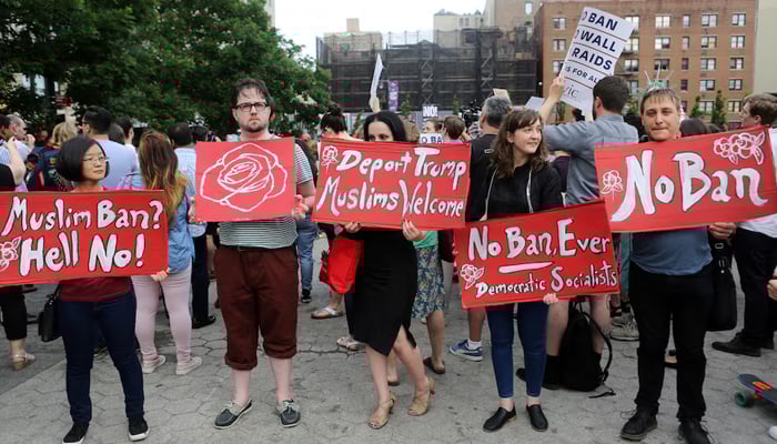 Protesters have signs against US President Donald Trump's Limited Travel Ban, approved by the US Supreme Court, in New York City, USA, June 29, 2017. - Reuters