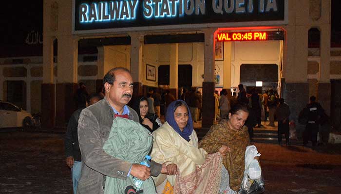 Passengers rescued from a train after it was attacked by militants go with their belongings at the railway station in Quetta, Balochistan, March 12, 2025. - Reuters 