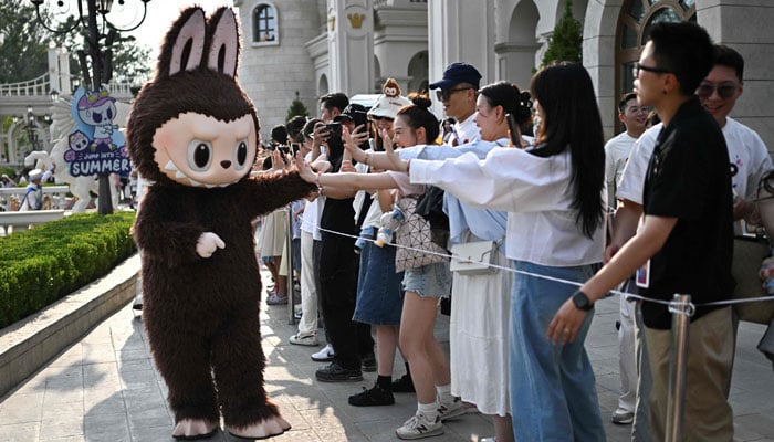 The character Labubu participates in a performance on Pop Mart Theme Park Park Land in Beijing, China on June 18, 2025. - AFP