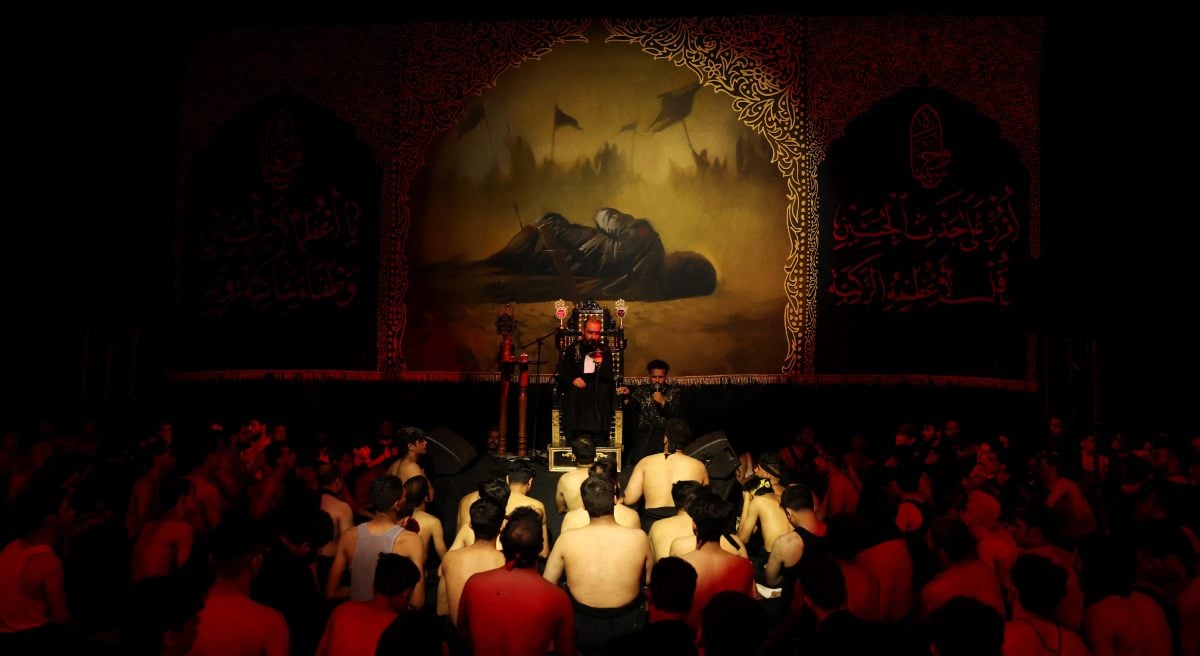 Mournful listening to a religious reciter under a grief collection that marks Ashura in Baghdad, Iraq, July 6, 2025. - Reuters