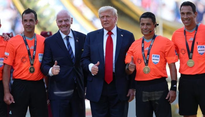 US President Donald Trump and FIFA President Gianni Infantino make up a photo with Judge Alireza Faghani and his assistant judge in the FIFA Club World Cup final, Metlife Stadium, East Rutherford, New Jersey, USA, July 13, 2025. -Reuters