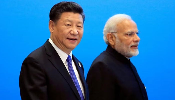 China's President Xi Jinping and India's Prime Minister Narendra Modi arrive at a signing ceremony during the SCO summit in Qingdao, Shandong, China. - Reuters/file