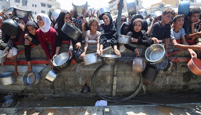 Palestinians are waiting to receive food from a charity kitchen, in the middle of a hunger crisis, in Gaza City, August 2, 2025. - Reuters