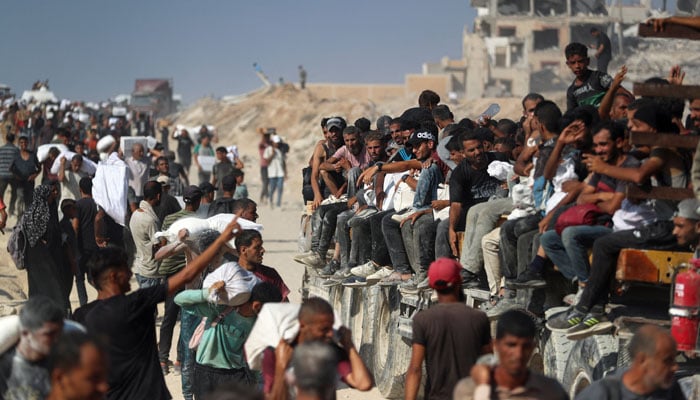 Palestinians carry help articles entering Gaza through Israel, in Beit Lahia, Northern Gaza Strip, August 2, 2025. - Reuters
