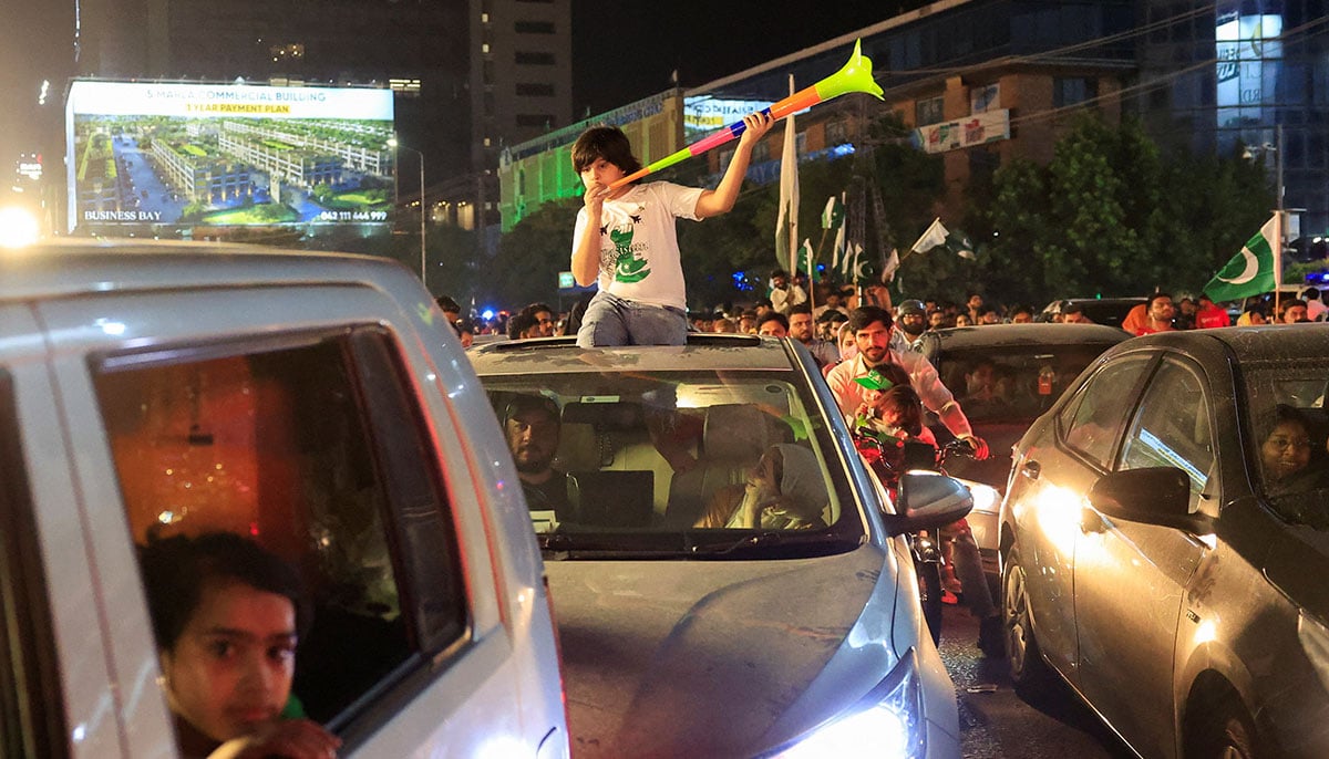 A child uses a vuvuzela under Independence Day -Remaining in Lahore on August 14, 2025. - Reuters