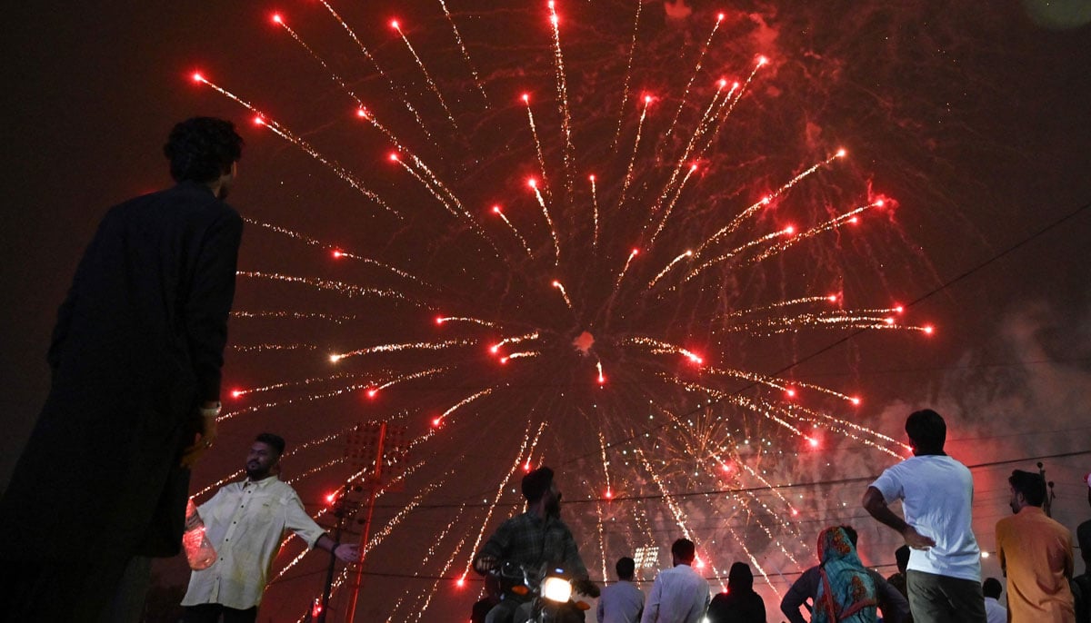 People see a fireworks display that appears in front of national stage during the celebration