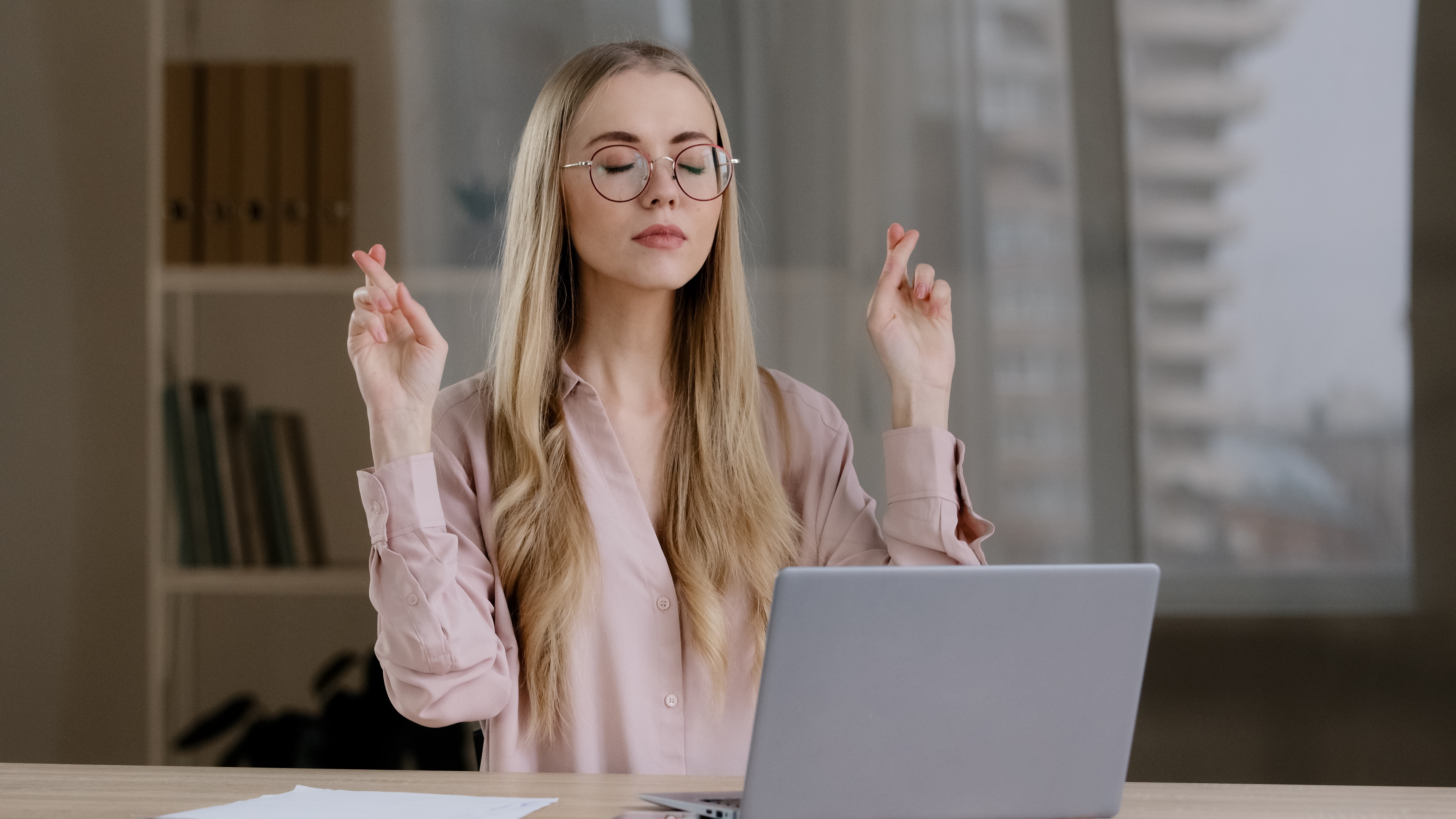 Girl uses laptop in hopes of good luck with your fingers crossed