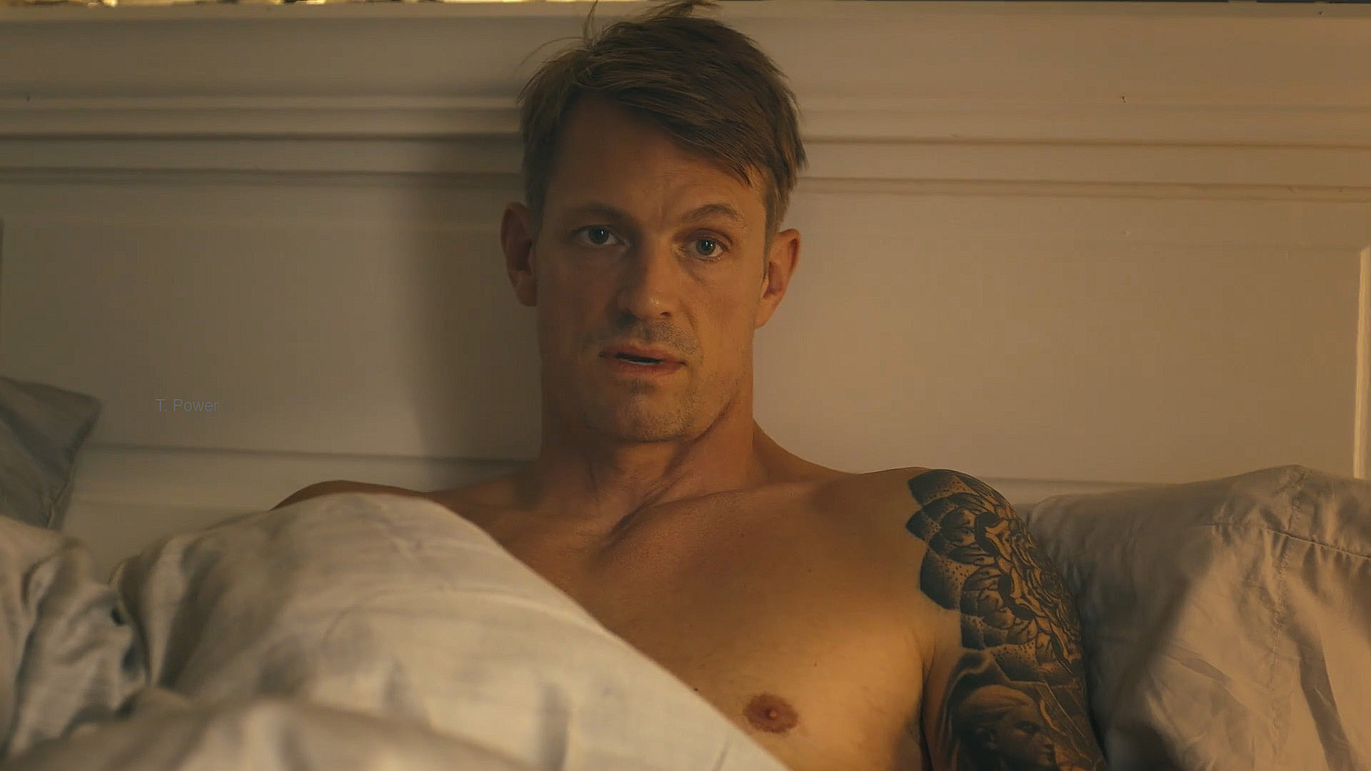 A topless Rick Flag Jr that sits up in a bed in Peacemaker Season 2 Section 3