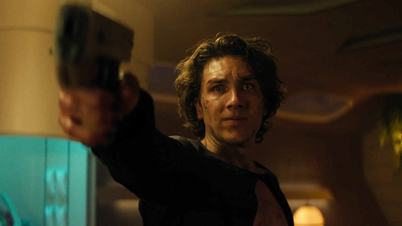 A Tearing Guard Toran Mallow Brandishing A handgun in Foundation Season 3 Section 7