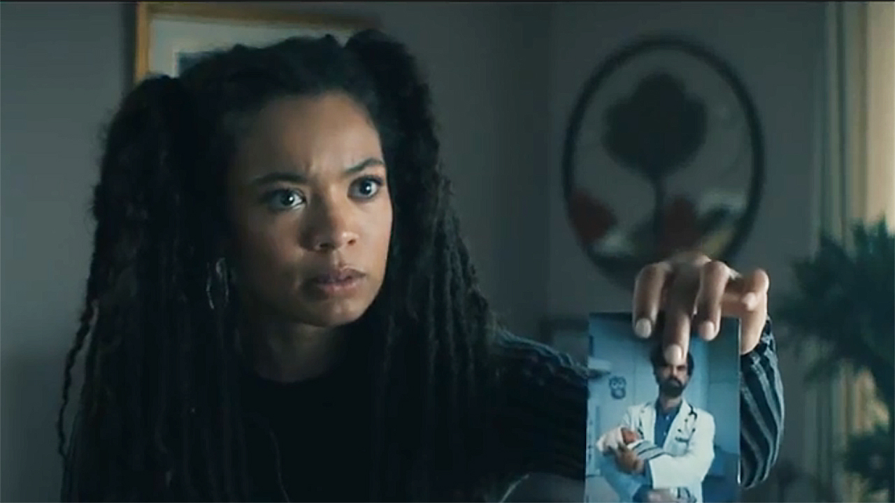 A surprised Marie holding a picture of chiffer/doctor Gould in Gen V Season 2 Section 3