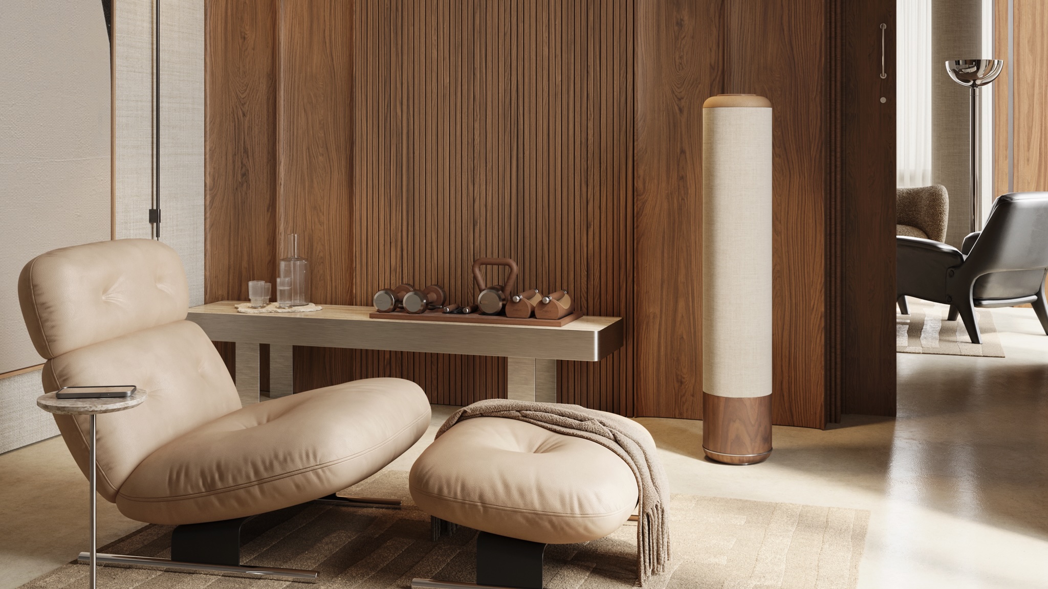 Pent. Audio Chiara -speaker next to a wooden panel wall with a large lounge chair in the foreground