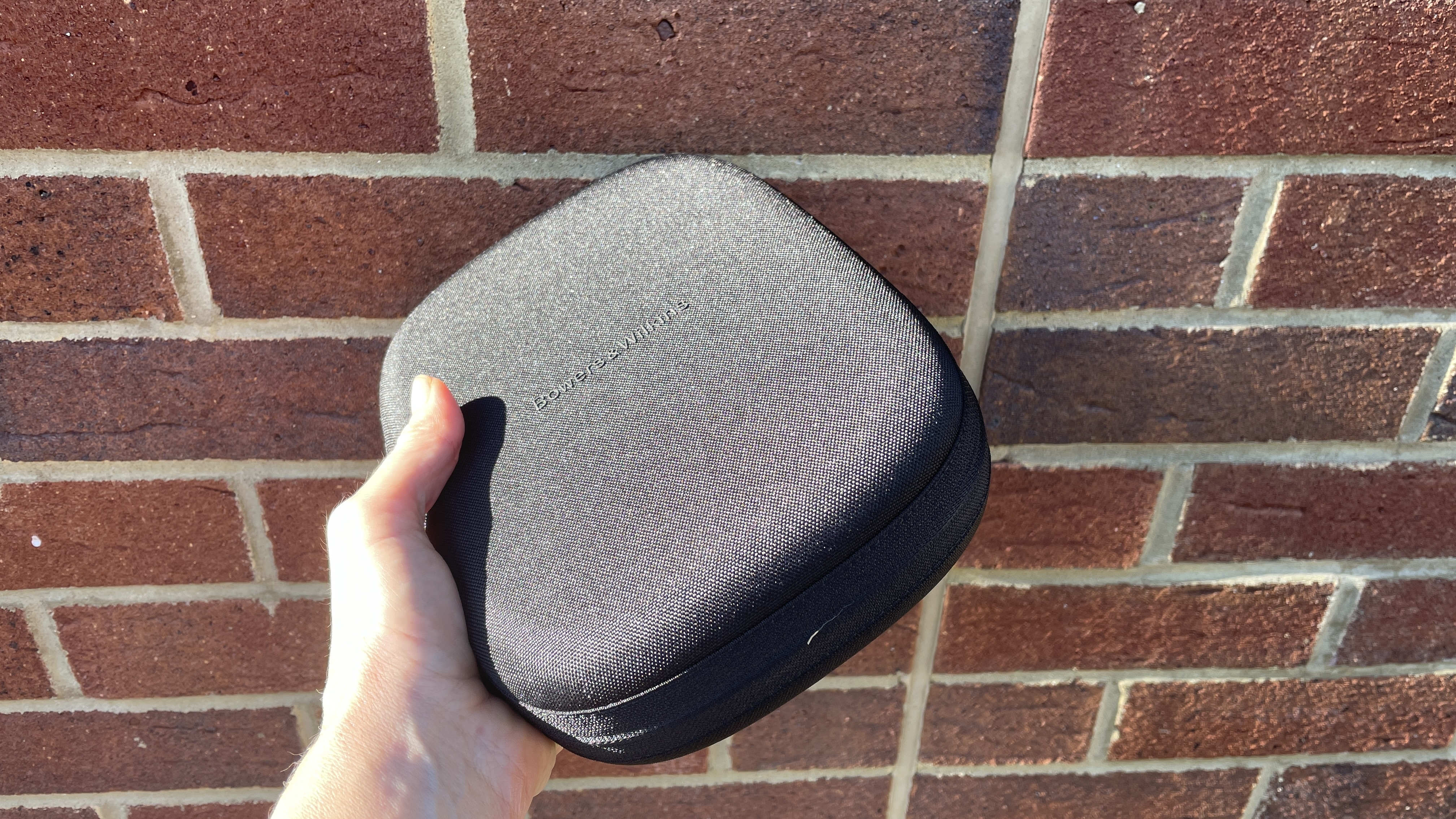 Bowers & amp; amp; Wilkins PX8 S2 in front of a red wall wall