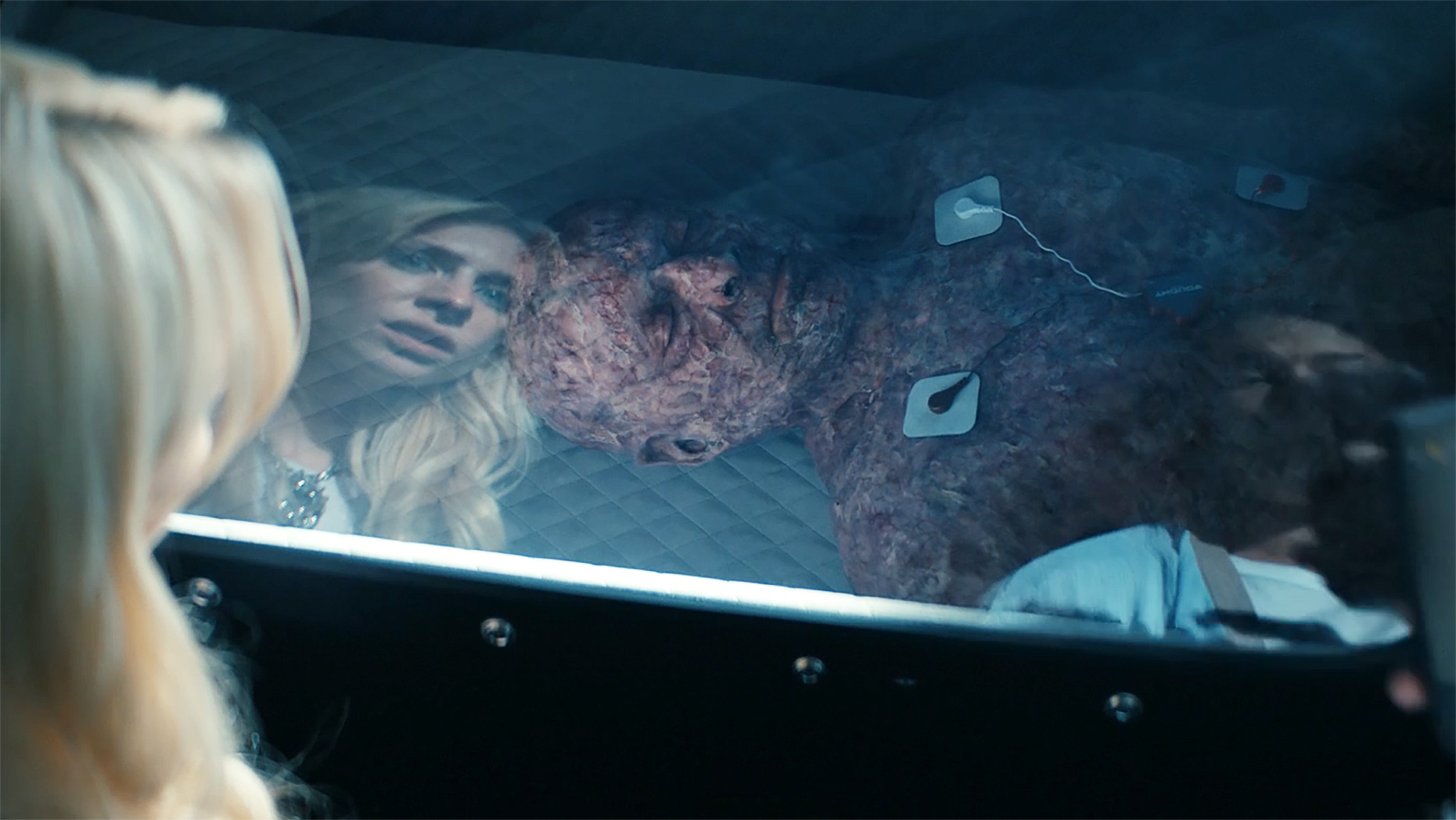 Cate and Jordan stare at a scared man in a hyperbar chamber in Gen V season 2 section 4