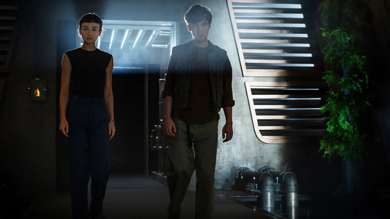 Wendy and Joe are in a weakly lit room in Alien: Earth Season 1 Section 8