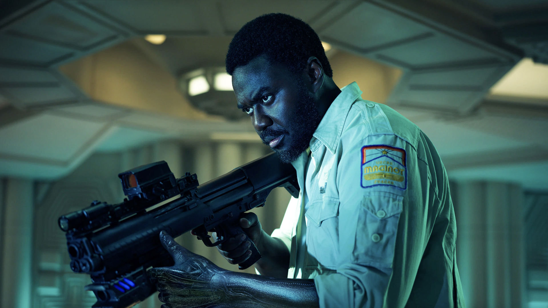 MORROW brandishing a rifle in alien: the earth