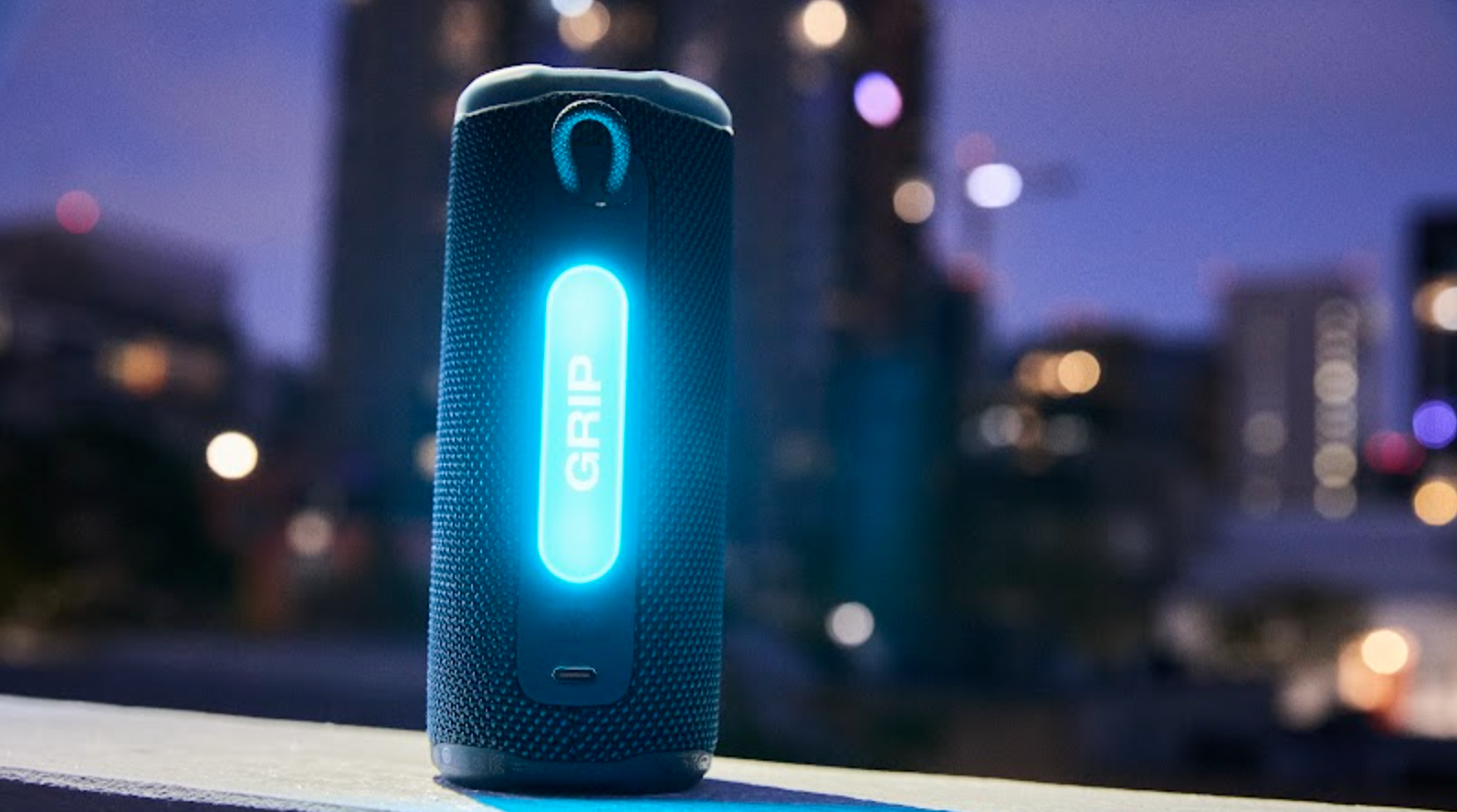 JBL grabbed in front of a skyline showing its illuminated surrounding light panel