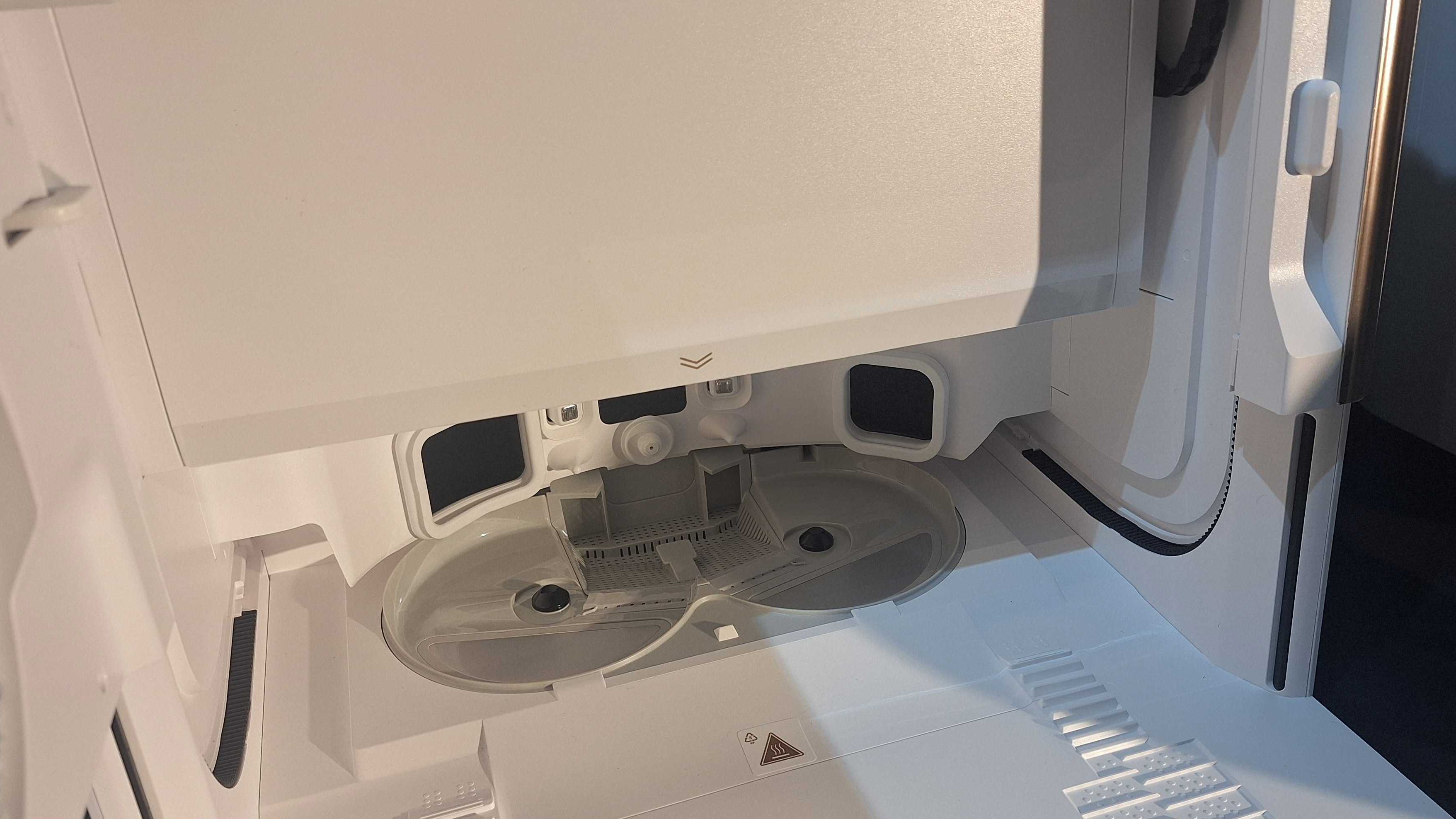 Photo showing the inside of Dream Matrix10 Ultra's Dock, with space for mop pads to sit and attach to the robot wacuum