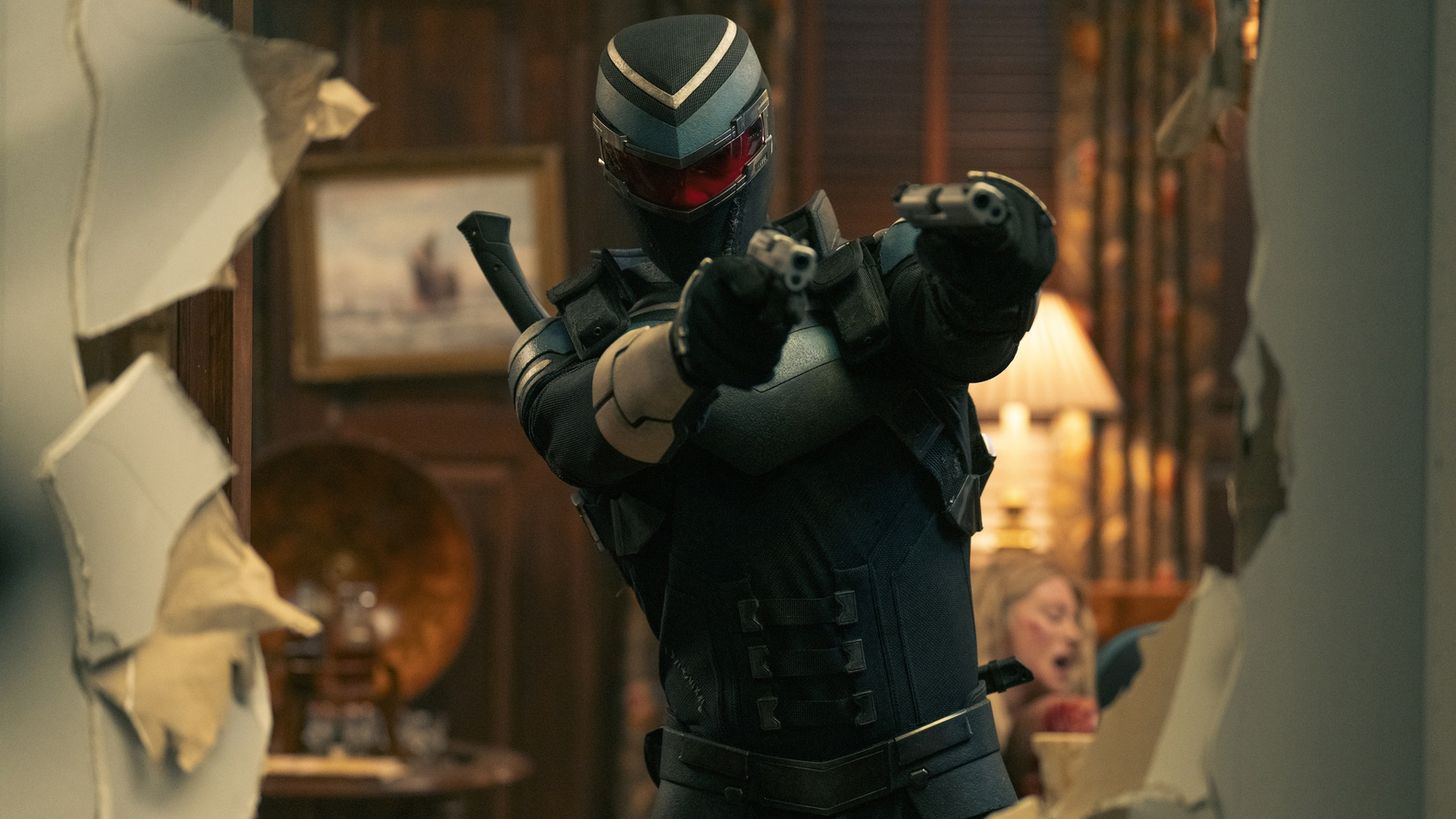 Adrian Chase/Vigilante with his handguns raised in Peacemaker season 2 section 7