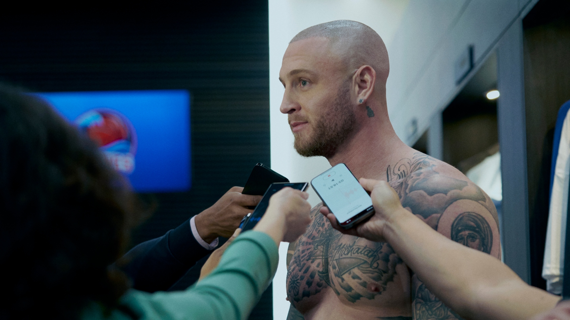 Travis is talking to the press in running point