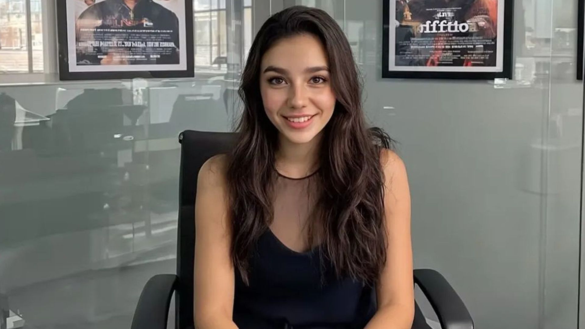 Tilly Norwood, an AI actor, sitting in an office and looking at the camera