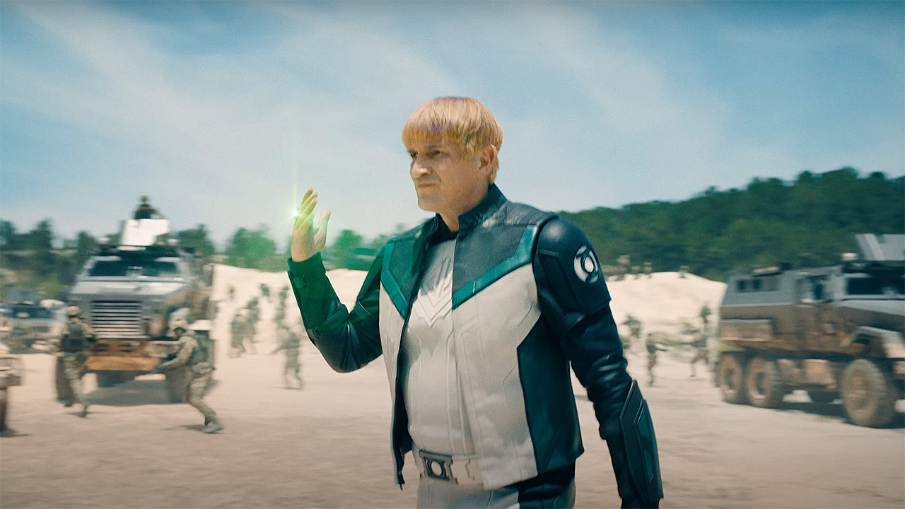 Guy Gardner who activates his green lantern ring in a desert area in Superman