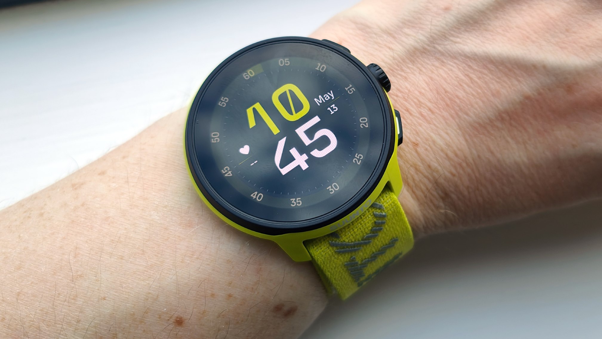 Wrists wearing yellow suunto running