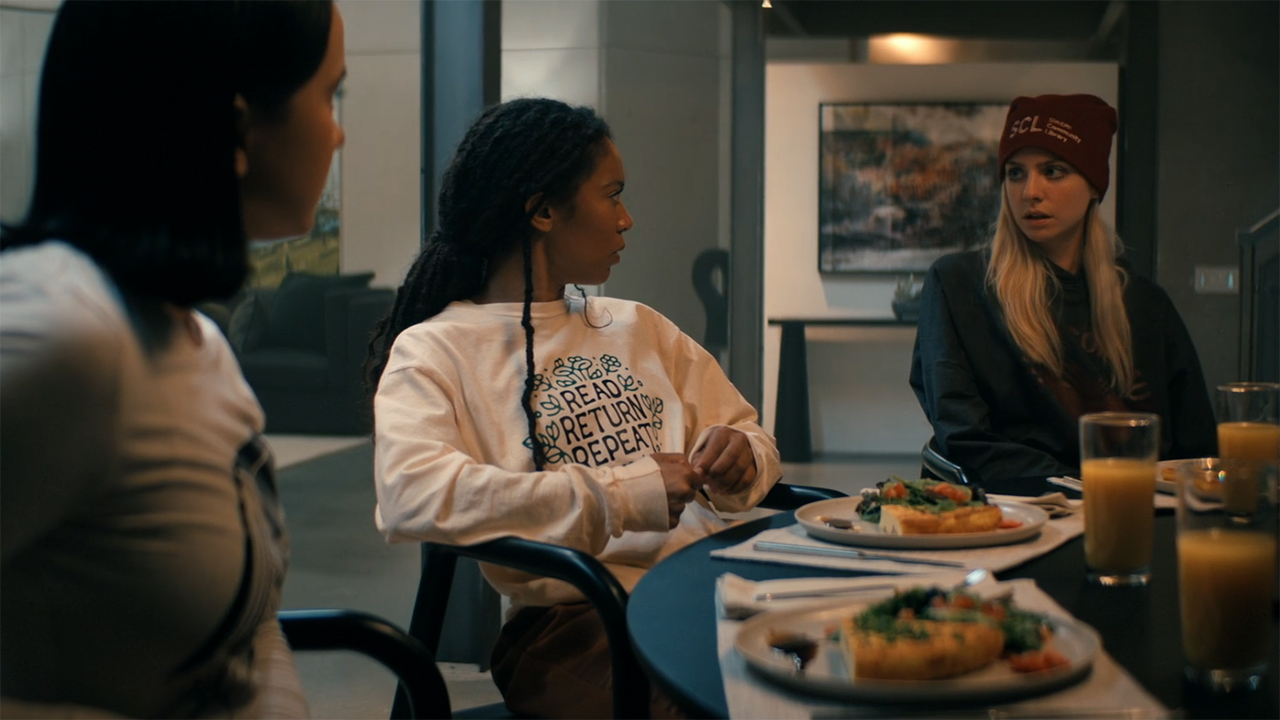 Jordan and Marie look at Cate when sitting at a table filled with food in Gen V season 2 section 6