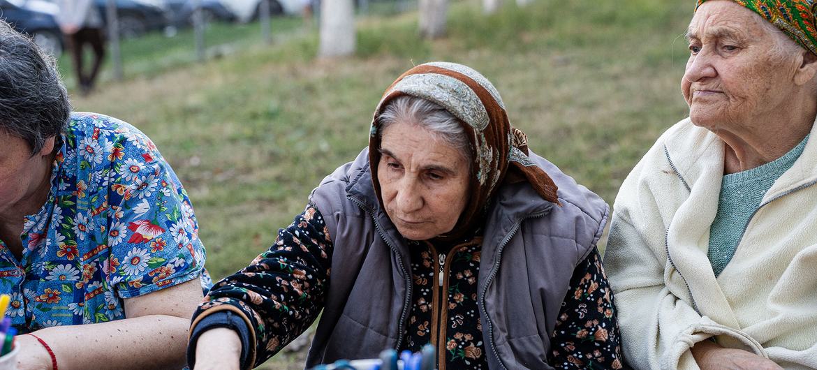 Ana (center) sits with other older women who have sought support in the center of Chișinu.