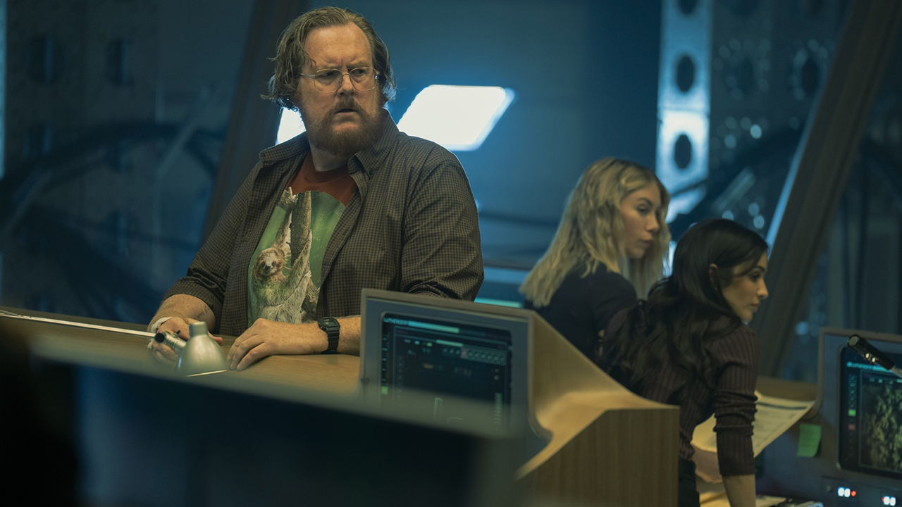 John Economos Standing on Argus HQ with Emilia Harcourt and Sasha Bordeaux in the background of Peacemaker Season 2 section 8