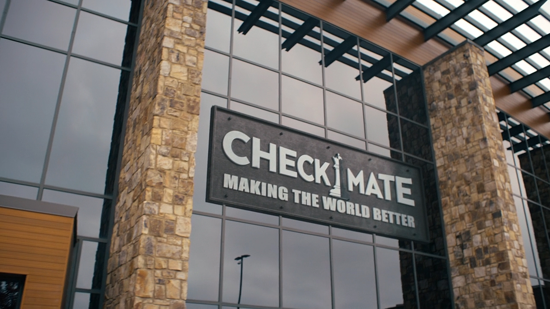 A Screenshot of the CheckMate Agency logo on a building front in Peacemaker season 2 section 8