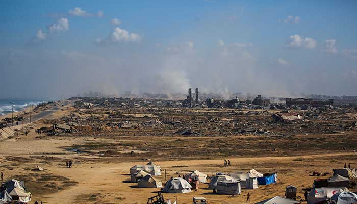 Palestinians walking around in tents in the NUSEIRAT in the Central Gaza Strip on October 10, 2025. - AFP
