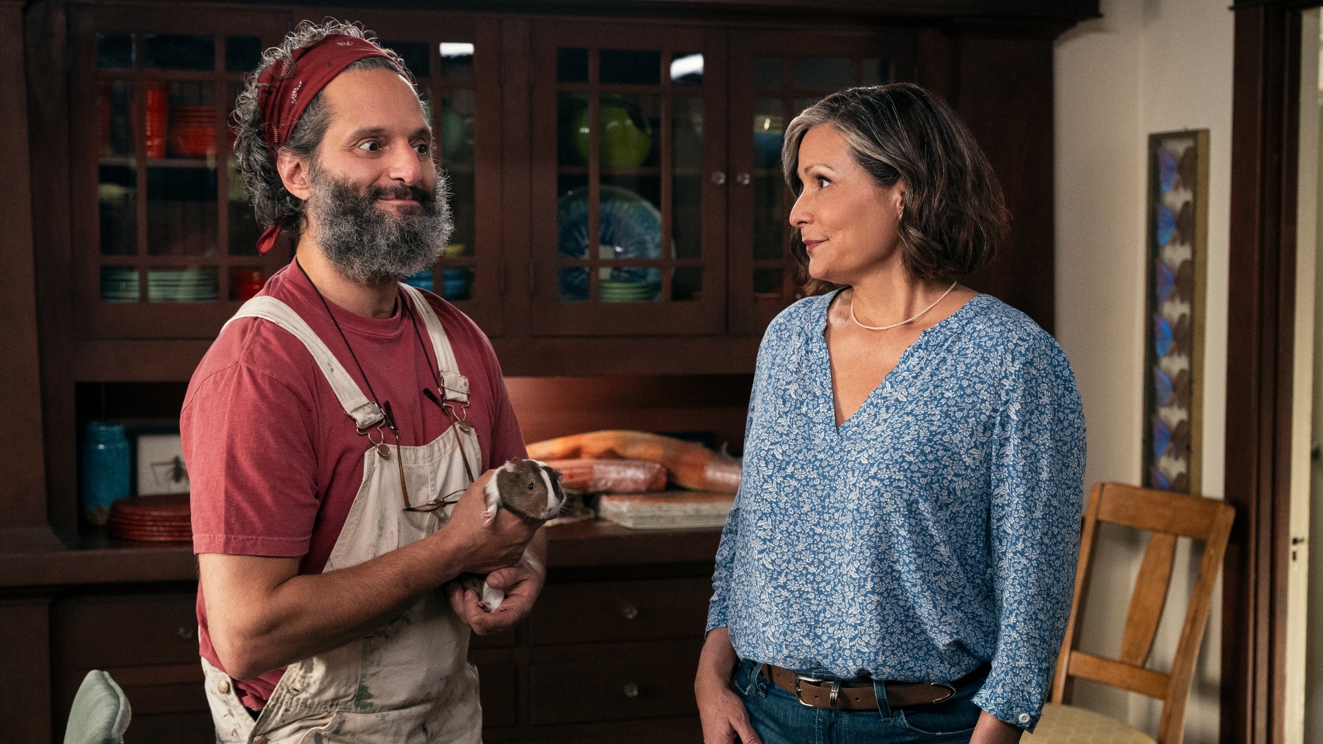 Apollo holds a guinea pig in A Man on the Inside Season 2