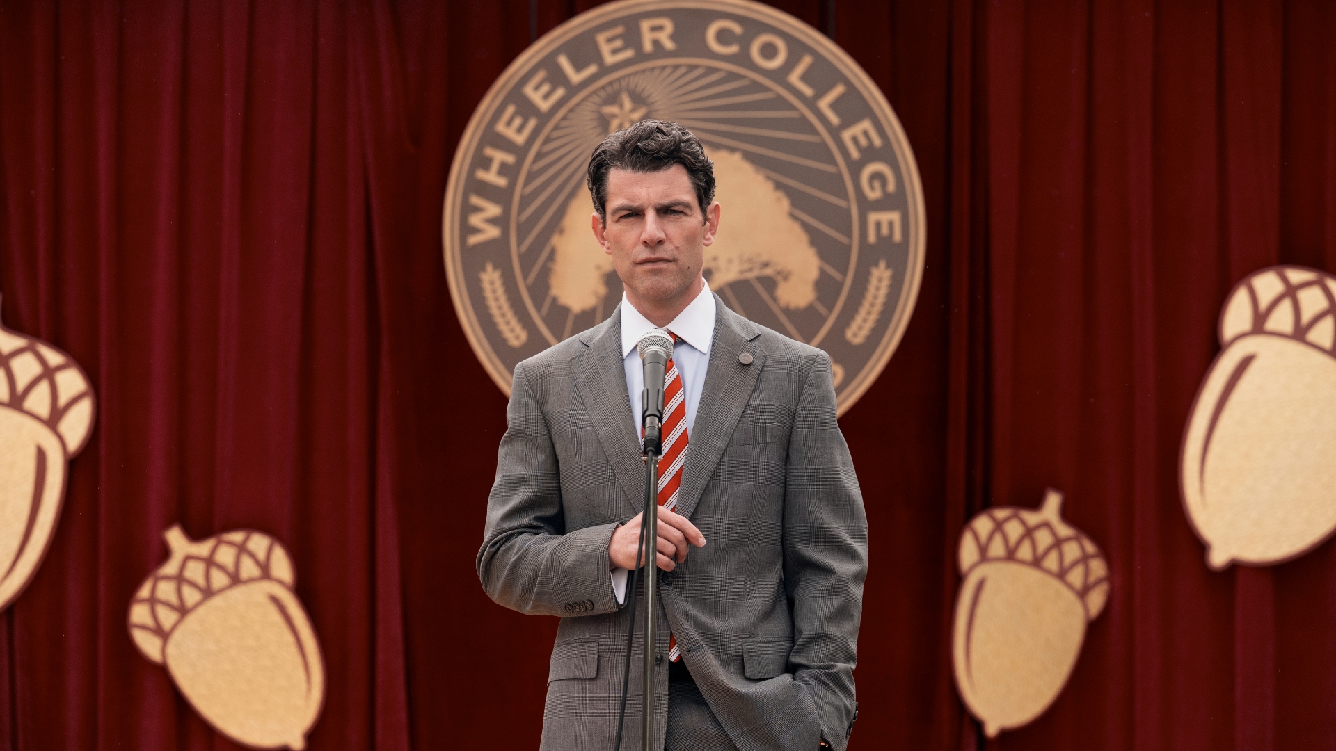 Jack stands at a microphone in A Man on the Inside Season 2