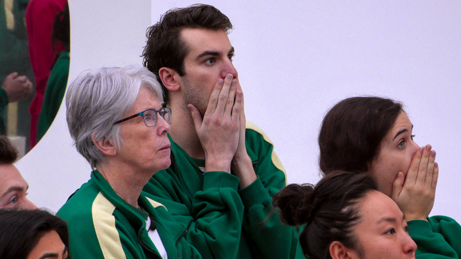 Shocked contestants put their hands to their mouths in Netflix's Squid Game: The Challenge