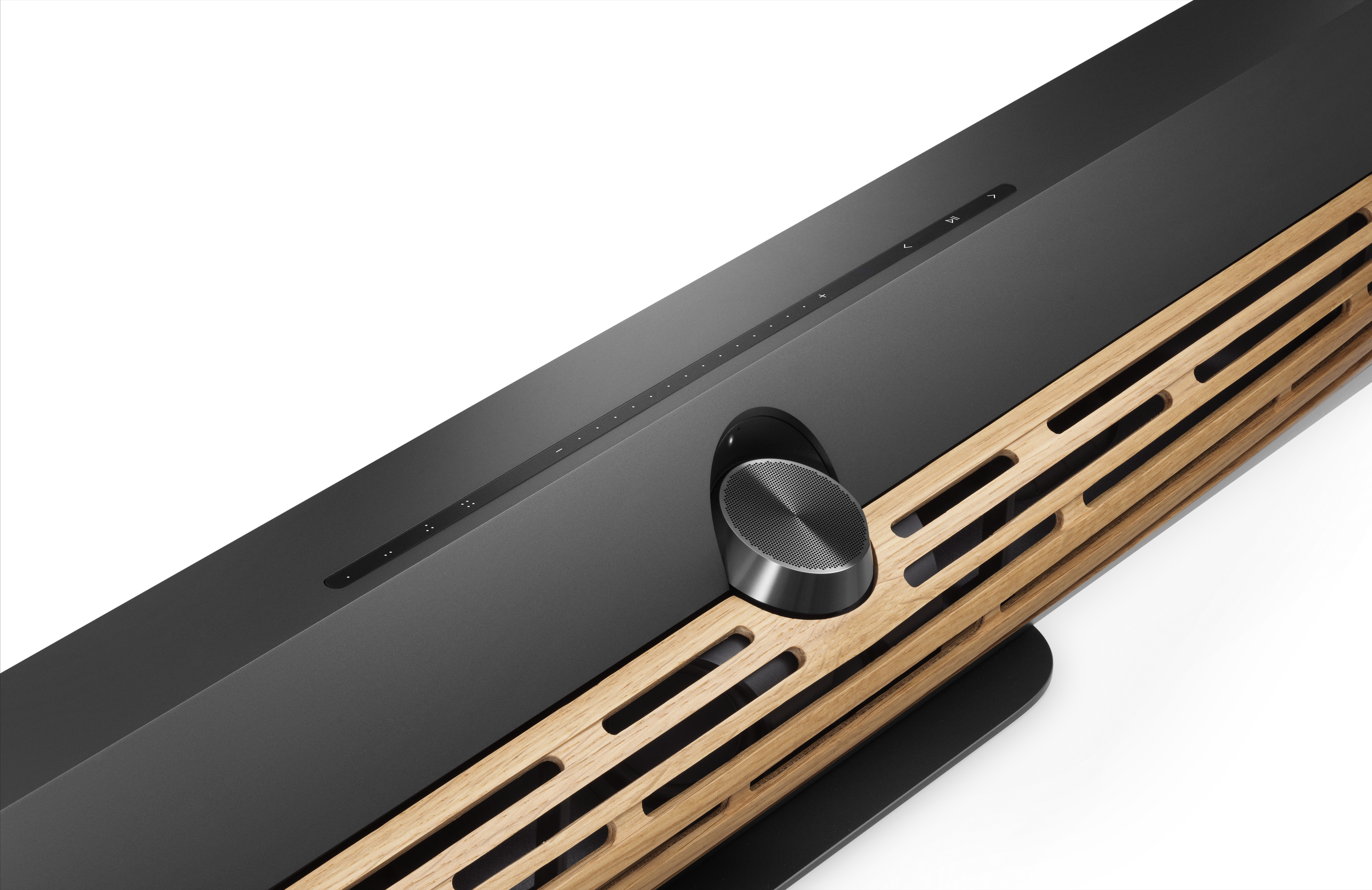 Close-up of Bang & Olufsen Beosound Premiere in black with wooden grille on white background