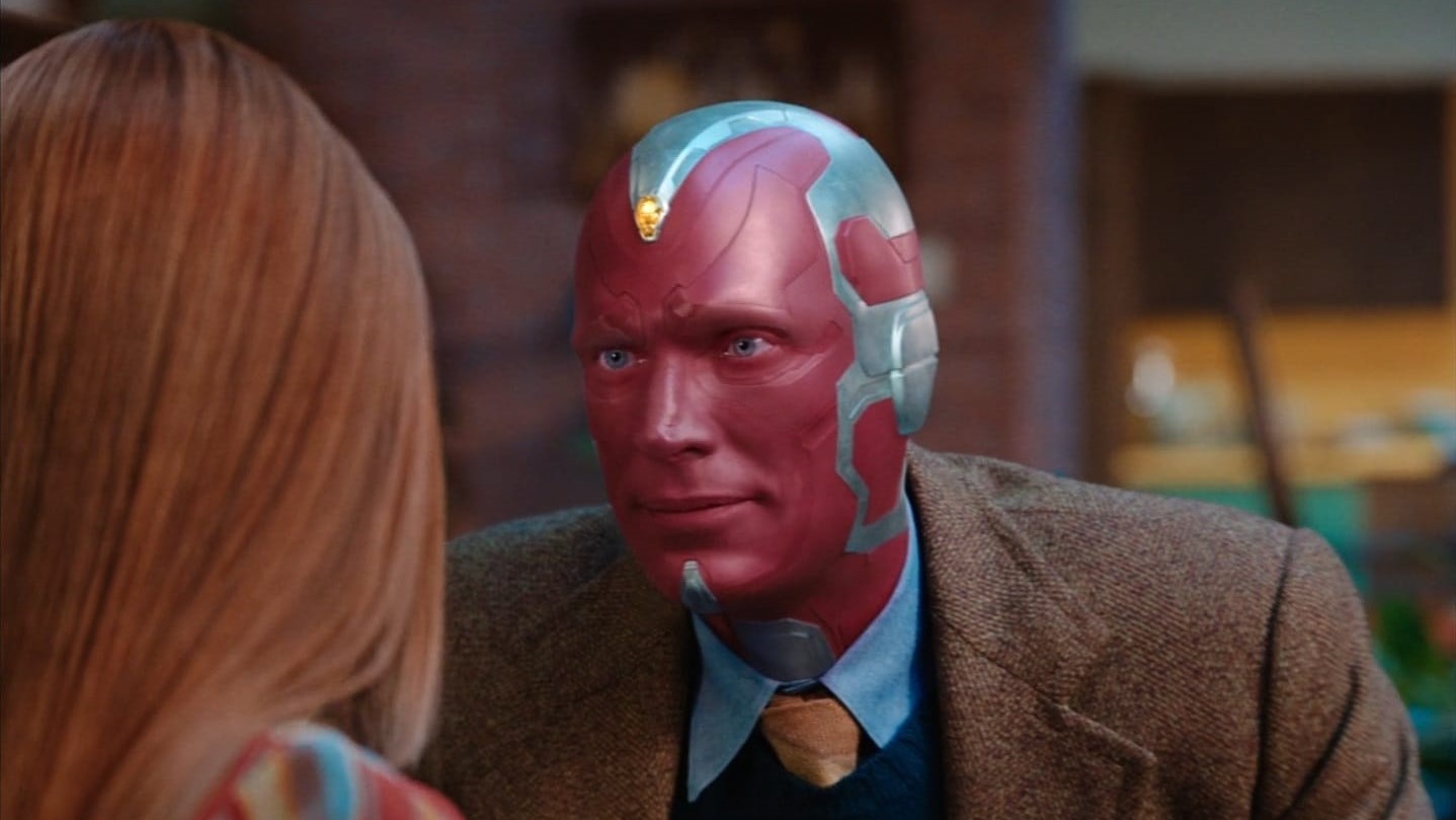 A fitting Vision looking at an off-camera Wanda Maximoff in WandaVision