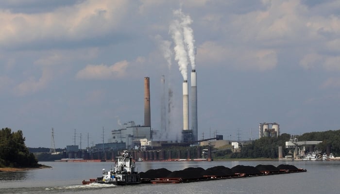 A tugboat pushes barges toward the Mill Creek Station power plant on the Ohio River in Louisville, Kentucky, U.S., September 15, 2017. — Reuters