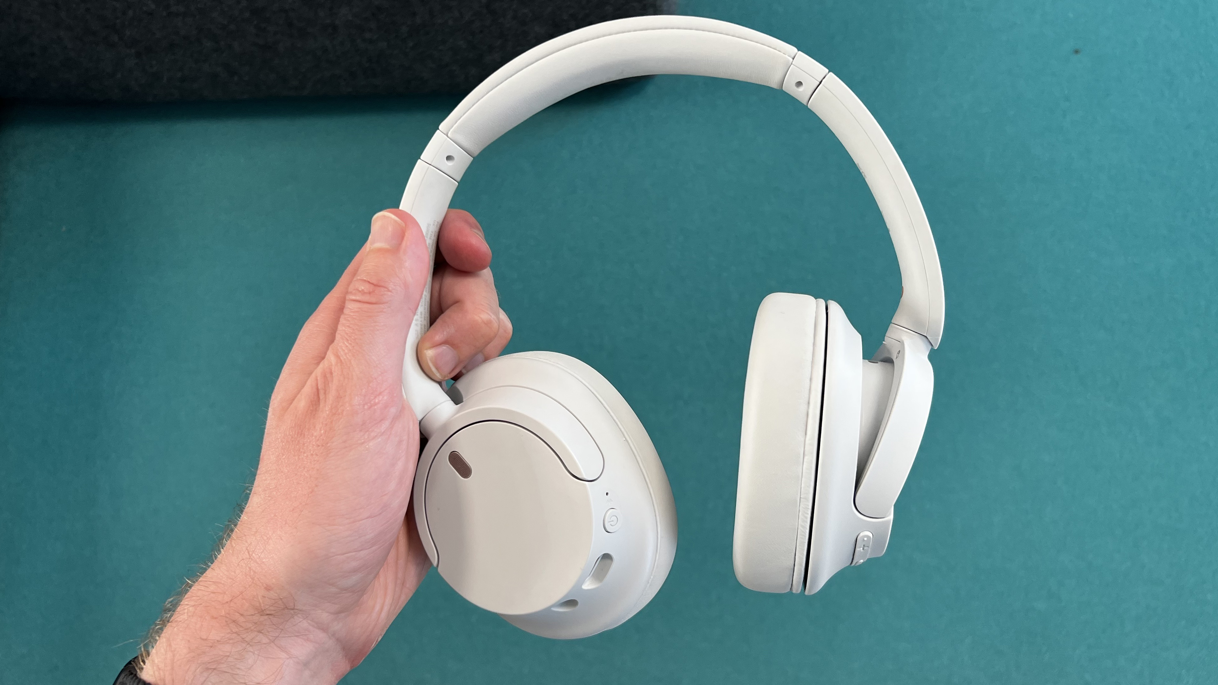 Sony WH-CH720N headphones held in hand
