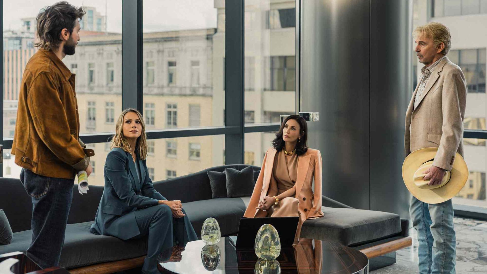 The crew of Landman in a boardroom