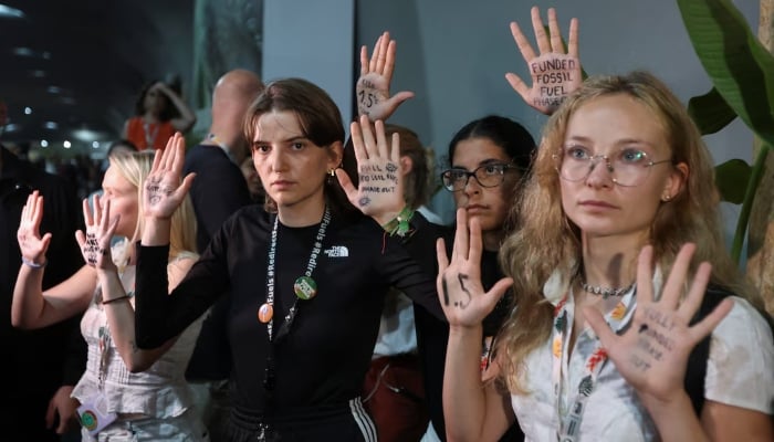 Activists show messages written on their hands as they take part in a protest as COP 30 negotiators leave the meeting room during the United Nations Climate Change Conference (COP30) in Belem, Brazil, November 21, 2025. — Reuters