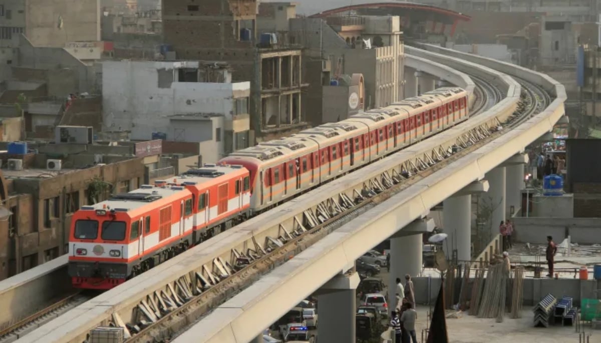 The Orange Line Metro Train runs on its first test run along a track in a neighborhood in Lahore on May 16, 2018. — Reuters