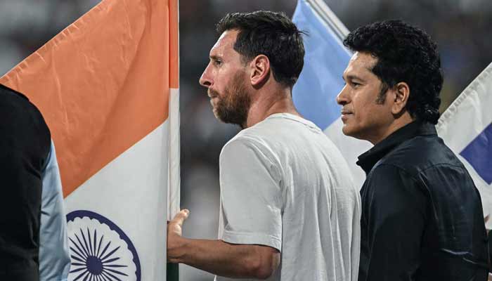 Argentina soccer player Lionel Messi (L) and India's former cricketer Sachin Tendulkar attend an event during Messi's Goat Tour at the Wankhede Stadium in Mumbai on December 14, 2025. — AFP