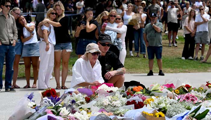 Mourners gather at a floral tribute at the Bondi Pavillion in memory of the victims of a shooting at Bondi Beach in Sydney on December 15, 2025. — AFP