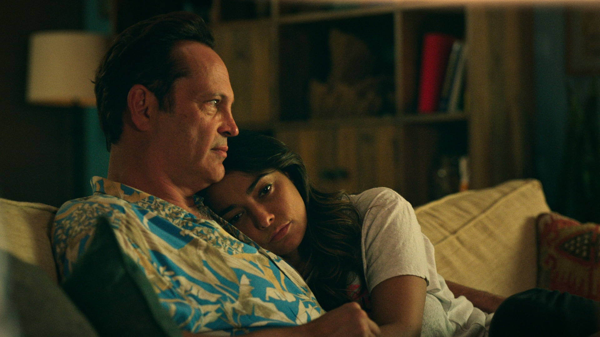 Yancy and Rosa hug on a sofa in Bad Monkey