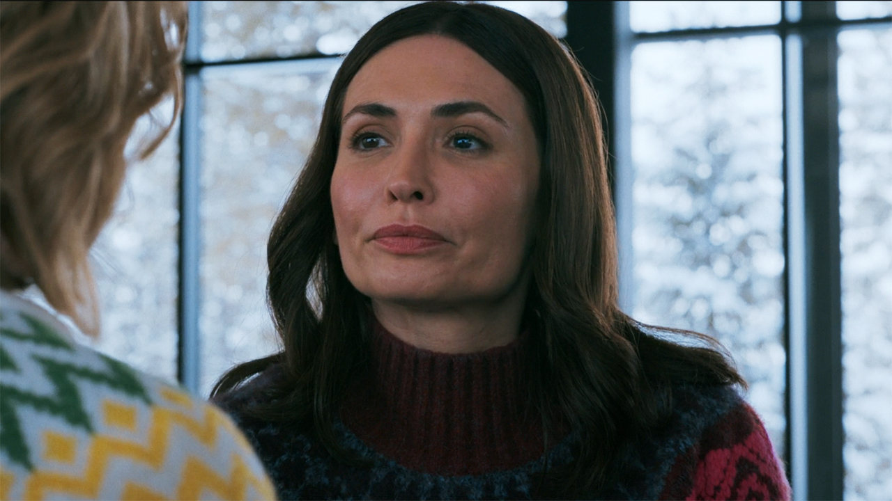 Zosia looks gloomy as she sits down and watches an off-screen Carol in Pluribus episode 9