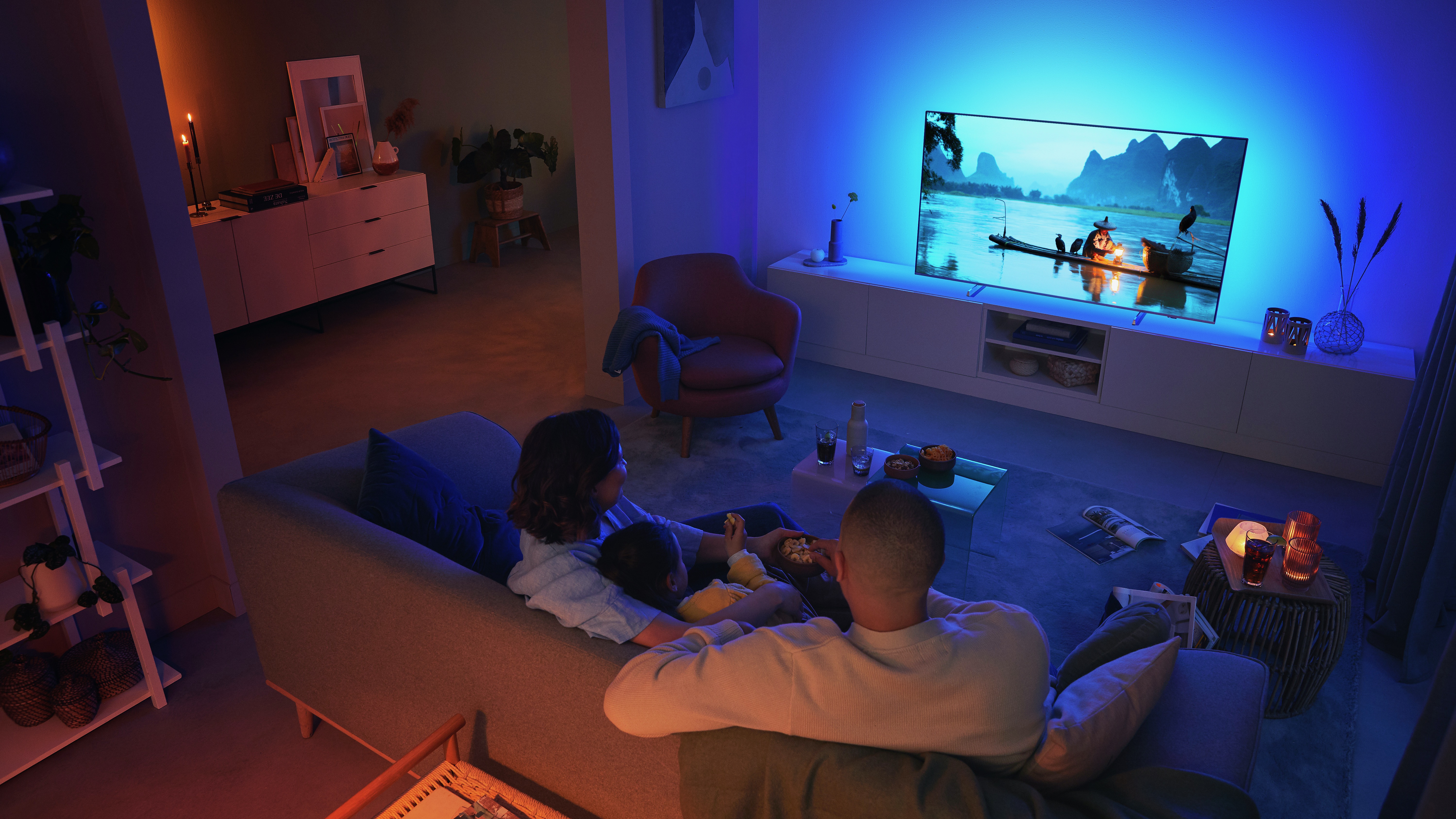 Couple watching a Philips Ambilight TV in the living room