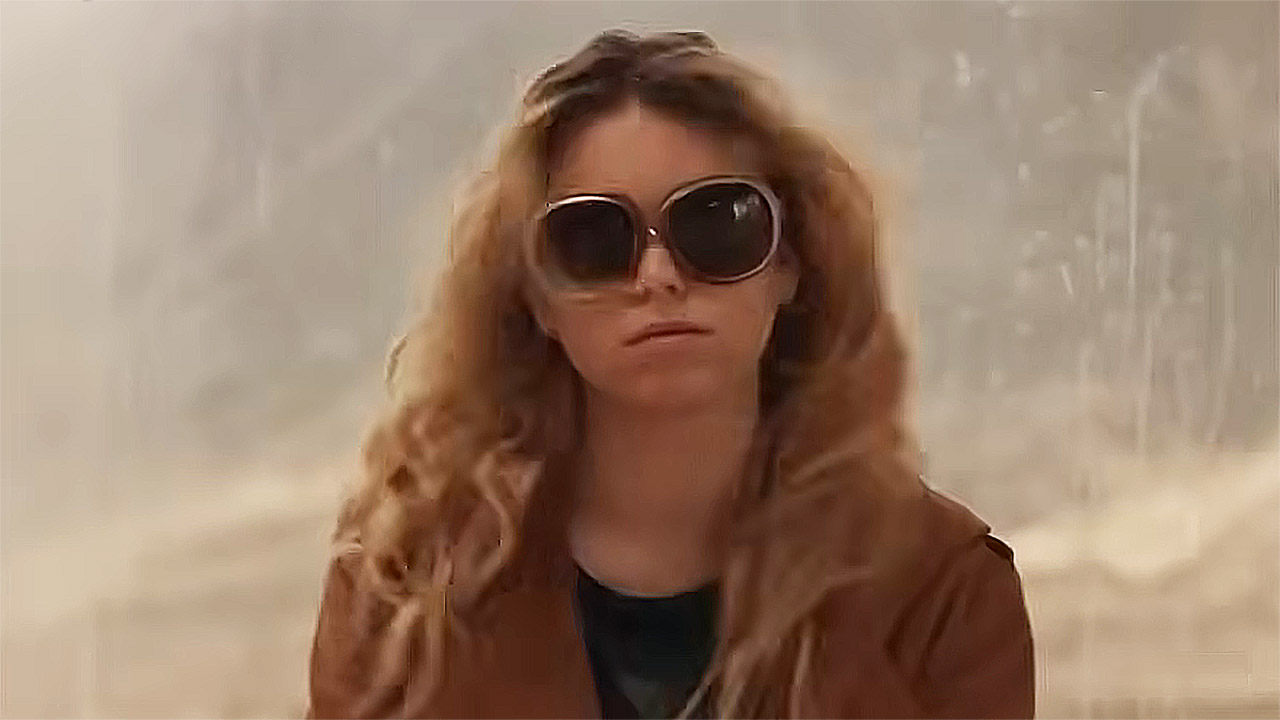 Milly Alcock's Kara Zor-El wearing a brown coat and sunglasses in the 2026 Supergirl movie