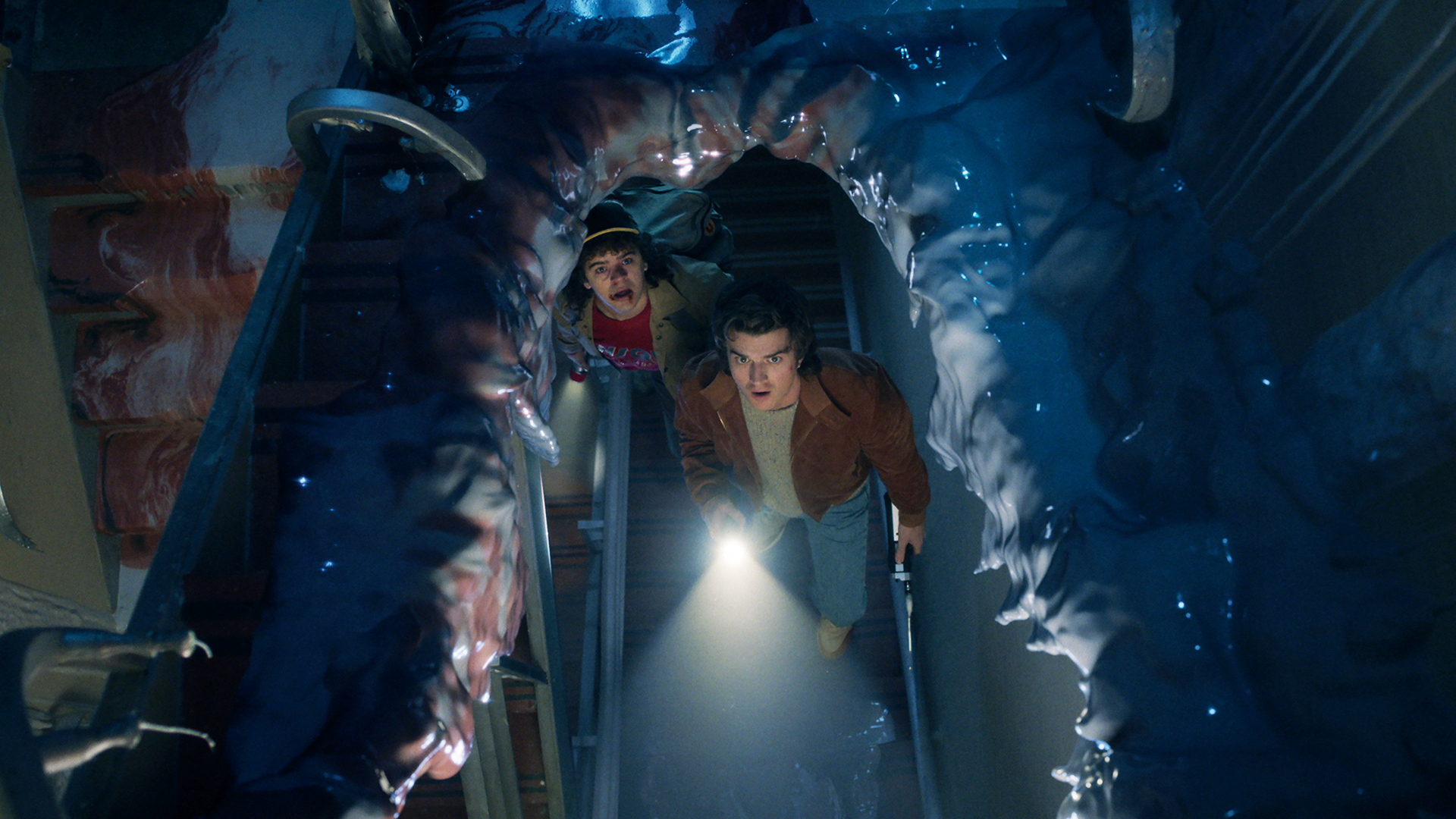 Dustin and Steve look up through a torn-up truck in Stranger Things Season 5