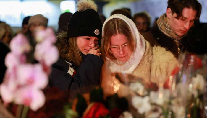 People react outside the Le Constellation bar after a fire and explosion during a New Year's party in the exclusive ski resort of Crans-Montana in southwestern Switzerland on January 1, 2026. — Reuters